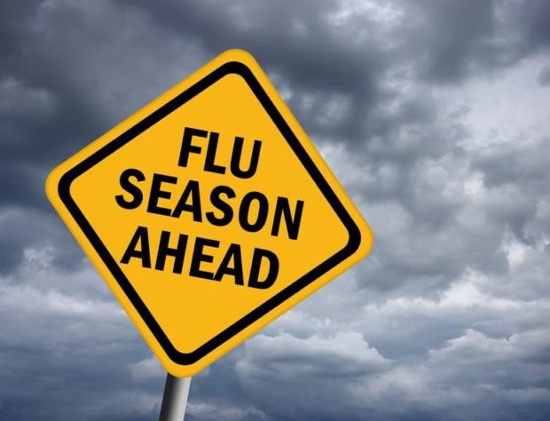 Yellow sign with "Flu Season Ahead" written on it