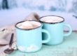 Cocoa in teal mugs on teal board